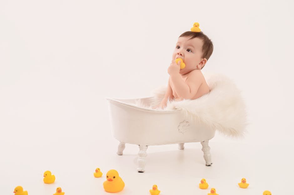 Cute baby sitting in a bathtub surrounded by rubber ducks, creating a playful and joyful scene.