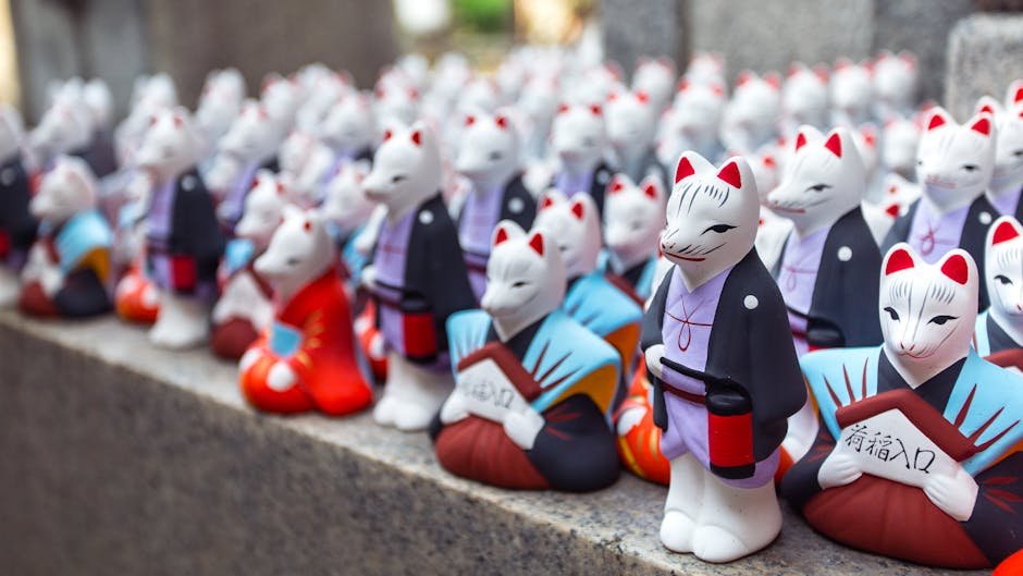 Vibrant and traditional Japanese fox figurines at a shop in Kyoto, Japan.