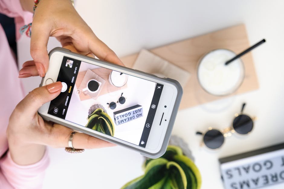 A woman captures a stylish flat lay setup with her smartphone.
