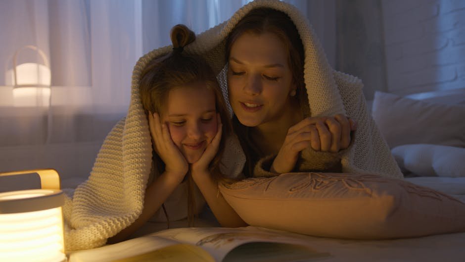 A mother and daughter sharing a cozy bedtime story under a blanket, creating a warm and loving atmosphere.