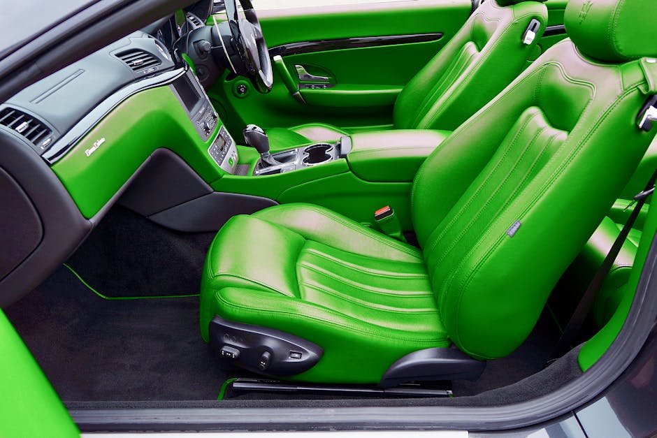 Close-up of luxury car's vibrant green leather interior featuring seats and dashboard.