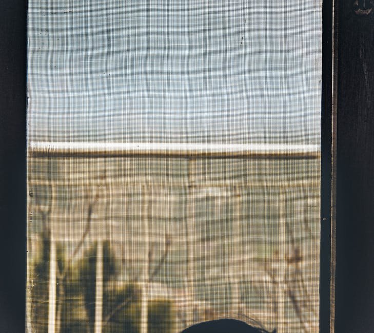A minimalist view through a mesh screen showing railings outdoors.