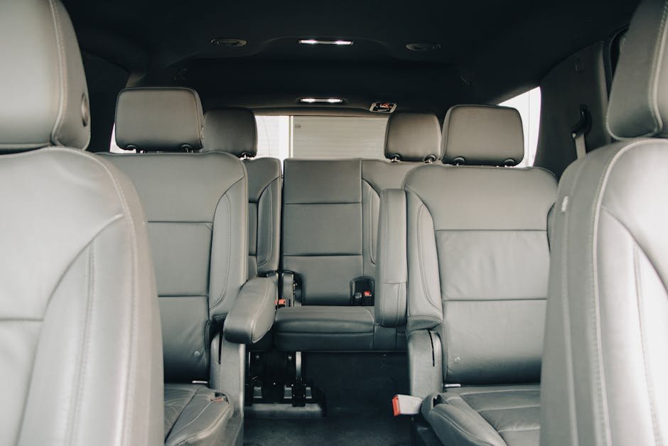 Explore the luxurious empty leather seats of a modern car interior, showcasing spacious design and comfort.