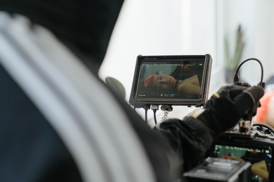 Close-up of a tattooing session displayed on a digital monitor, revealing the intricate details and technology involved.