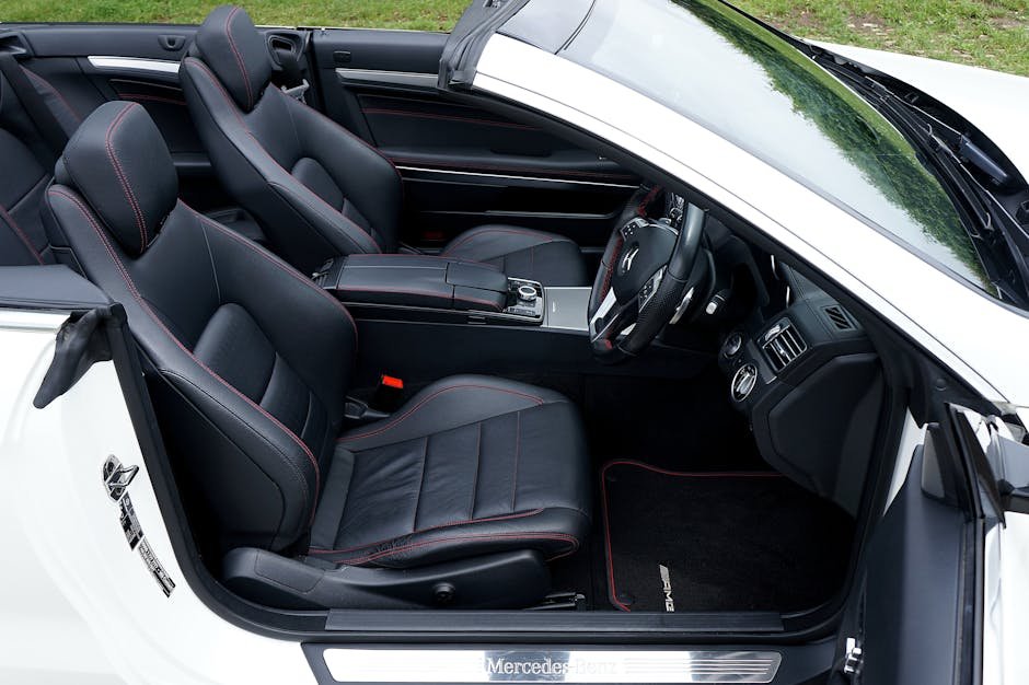 Explore the elegance of a luxury convertible car interior featuring premium black leather seats and detailed craftsmanship.
