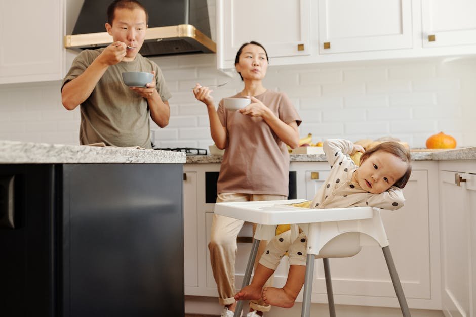 A family of three enjoying breakfast together in a modern kitchen setting.